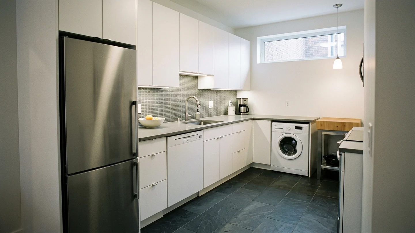 Compact condo kitchen with space-saving refrigerator dishwasher and laundry appliance
