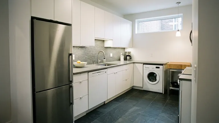 Compact condo kitchen with space-saving refrigerator dishwasher and laundry appliance