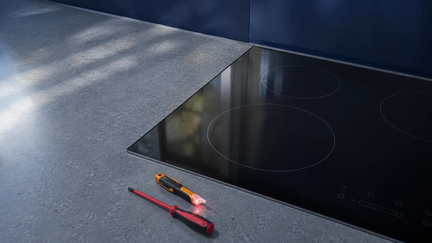 Electric appliance service tools beside a smooth cooktop